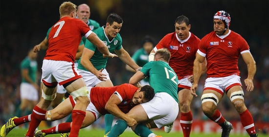 A Canadian player tackles an Irish player during a rugby match. Photo by Richard Heathcote.