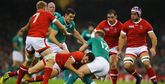 A Canadian player tackles an Irish player during a rugby match. Photo by Richard Heathcote.