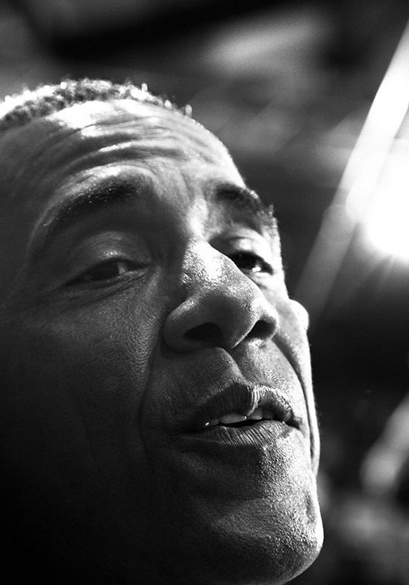 Obama is captured in extreme close-up while talking to a crowd member at one of his rallies.