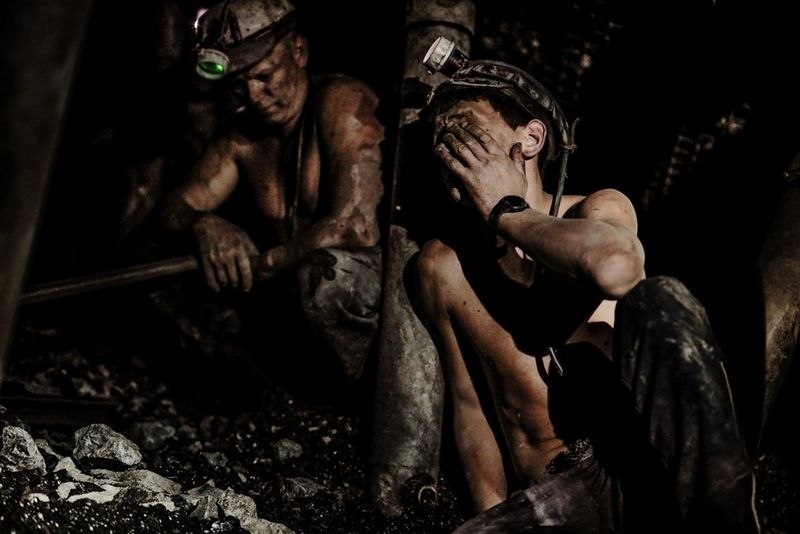 Two miners resting in a mineshaft, photographed by Daniel Etter on a Canon EOS R.