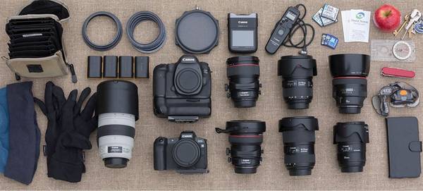 David Noton's kitbag laid out, with a Canon EOS 5DS R body, EOS R body, a selection of lenses and other equipment.