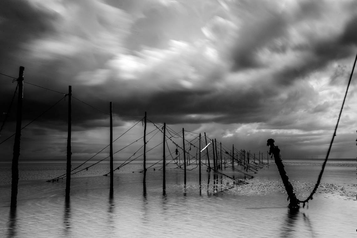 A black and white landscape photograph of a seascape by sports photographer Marc Aspland.
