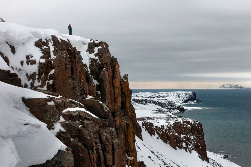 Snowy mountain with tiny figure on top, taken on a Canon EOS 5DS R by Paolo Verzone.