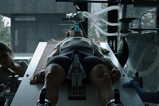 Filmmaker Bryan Fogel lies on a laboratory bed attached to a respirator. 