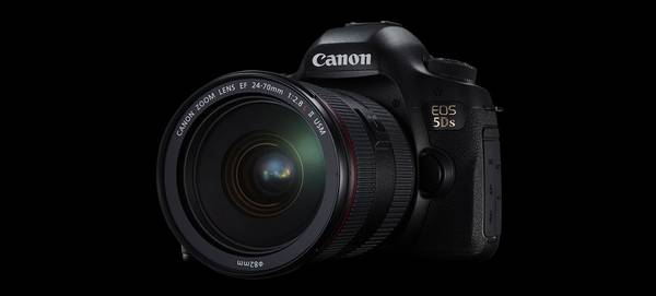 A Canon EOS 5DS camera sits against a black background.