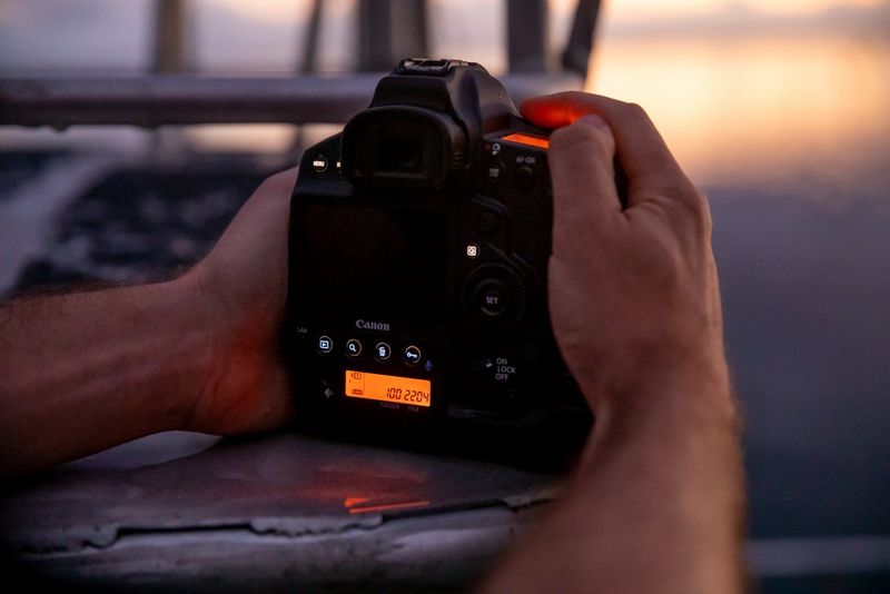 A view of the Canon EOS-1D X Mark III at dusk, showing the buttons illuminated.