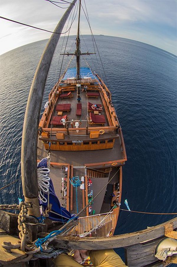 A fisheye lens shot shows an aerial view of a boat’s deck, taken from above.