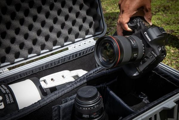 The Canon EOS-1D X Mark III being lifted out of a kitbag.