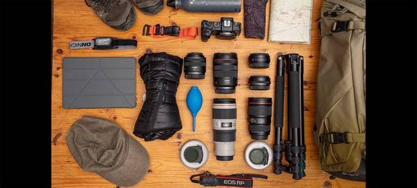 Gergo Kazsimer’s photography kitbag with lenses, hiking kit and a Canon EOS RP.