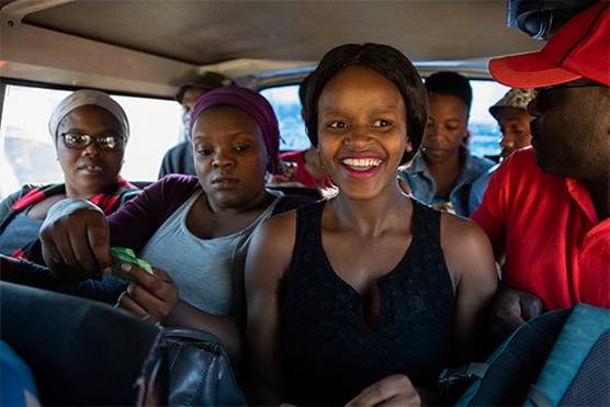 People in the back of a taxi in South Africa. Photo by Ilvy Njiokiktjien from her Born Free project.