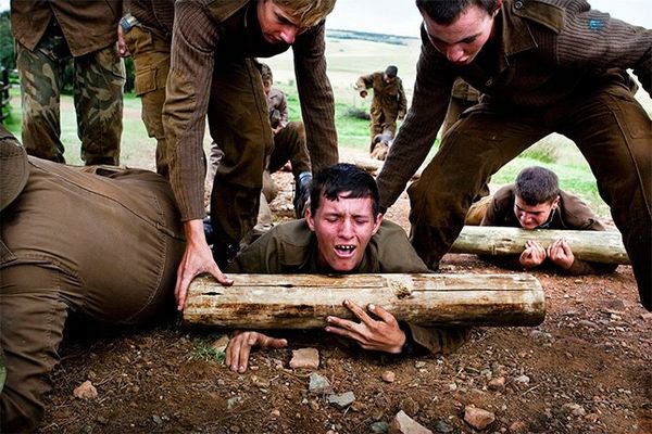 Teenage boys taking part in an assault course in South Africa.