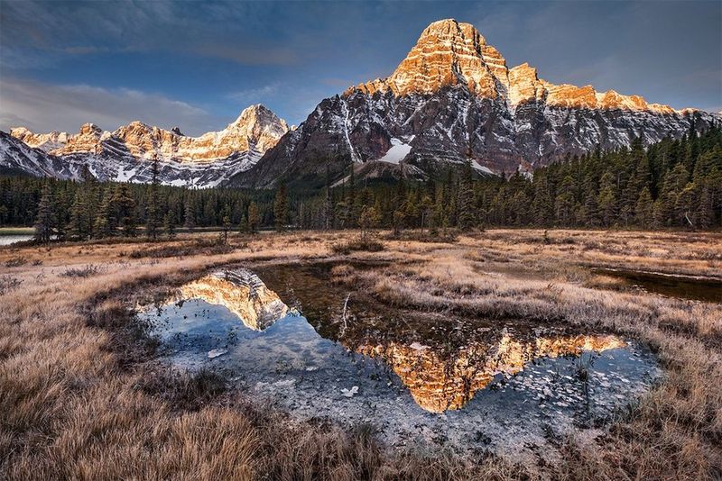 A mountain reflected in marsh water. Photo by Vladimir Medvedev on a Canon EOS 5D Mark II.