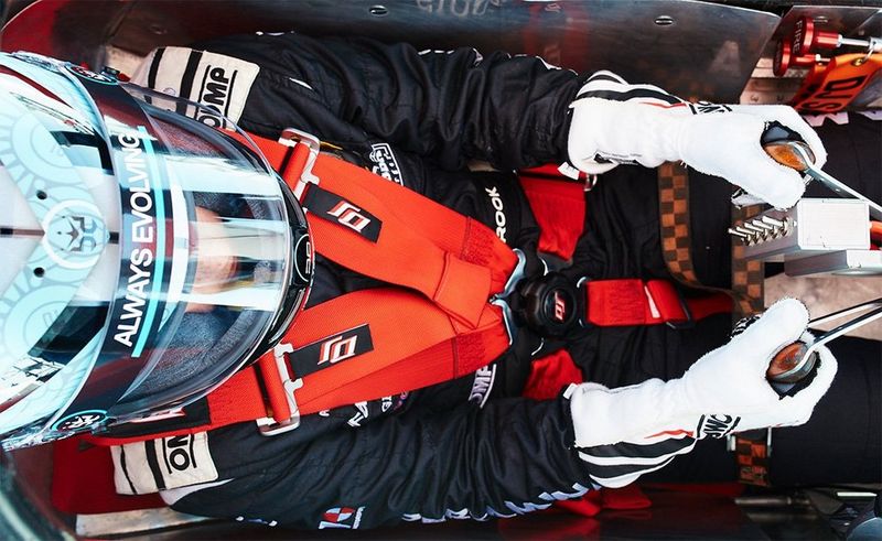 An overhead angle of a car racing driver.