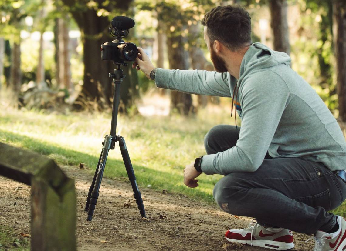 Stefan Michalak setting up to film a vlog in a park.