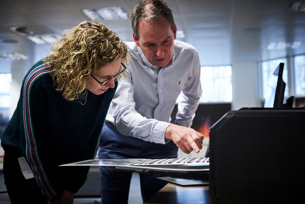 Helen Bartlett and Canon UK printing specialist Jay Sinclair watch closely as a print emerges from a Canon imagePROGRAF PRO-1000 printer. 