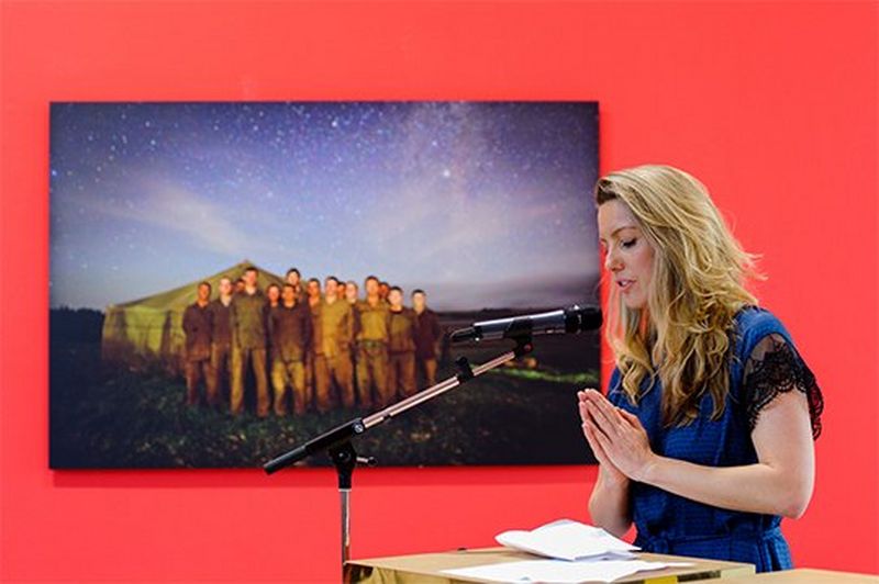 Ilvy Njiokiktjien speaks into a microphone at the opening of her Born Free exhibition.