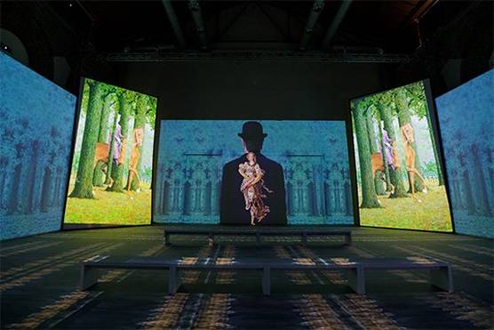 René Magritte's famous works projected across a room in an immersive exhibit in Milan.