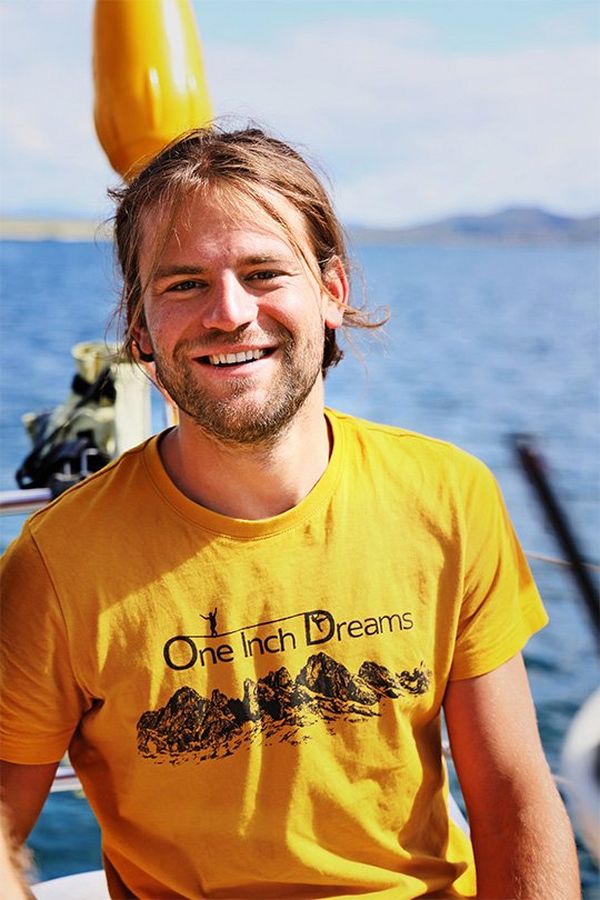A portrait of a man, one of the daredevils from One Inch Dreams, taken on a boat – he smiles at the camera.