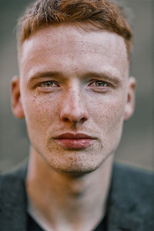 A close-up of a young man with freckles, crying. Photo by Rosie Hardy with a Canon RF 85mm F1.2L USM lens.