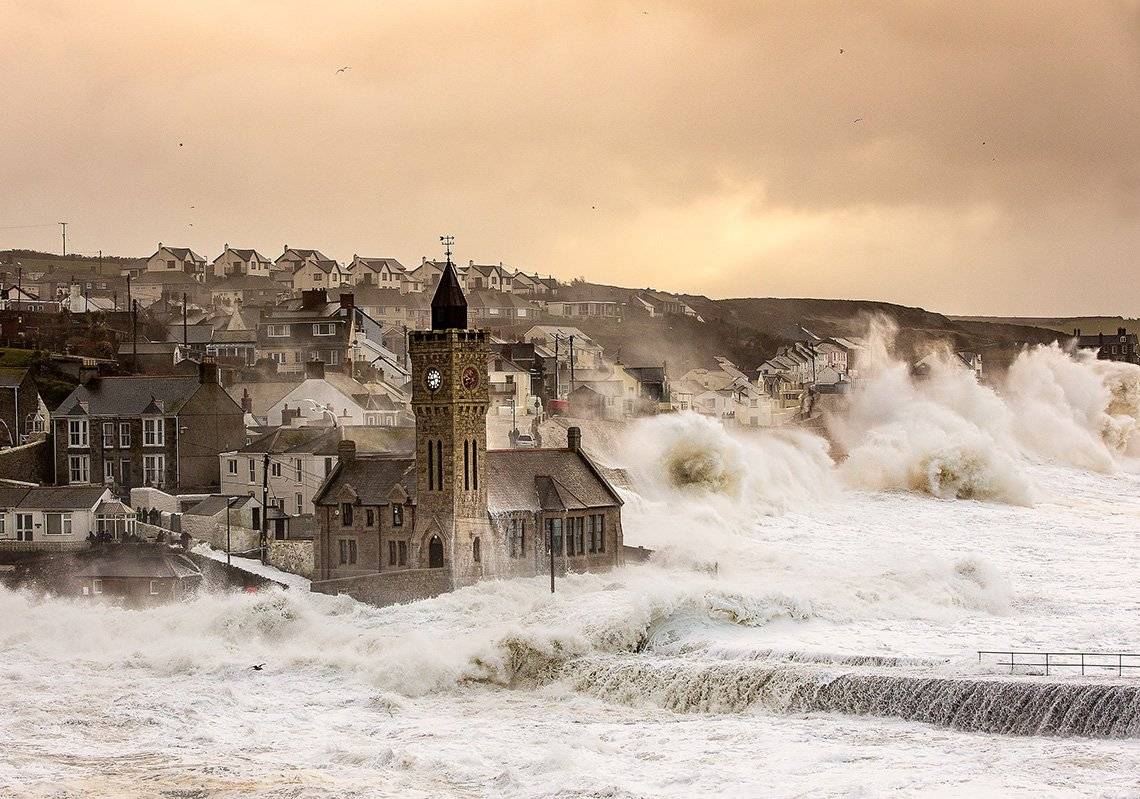 Waves crash over the sea wall during an early-morning storm at Porthleven in Cornwall. Photo by Carla Regler.