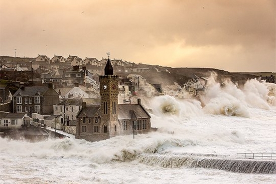 Waves crash over the sea wall during an early-morning storm at Porthleven in Cornwall. Photo by Carla Regler.