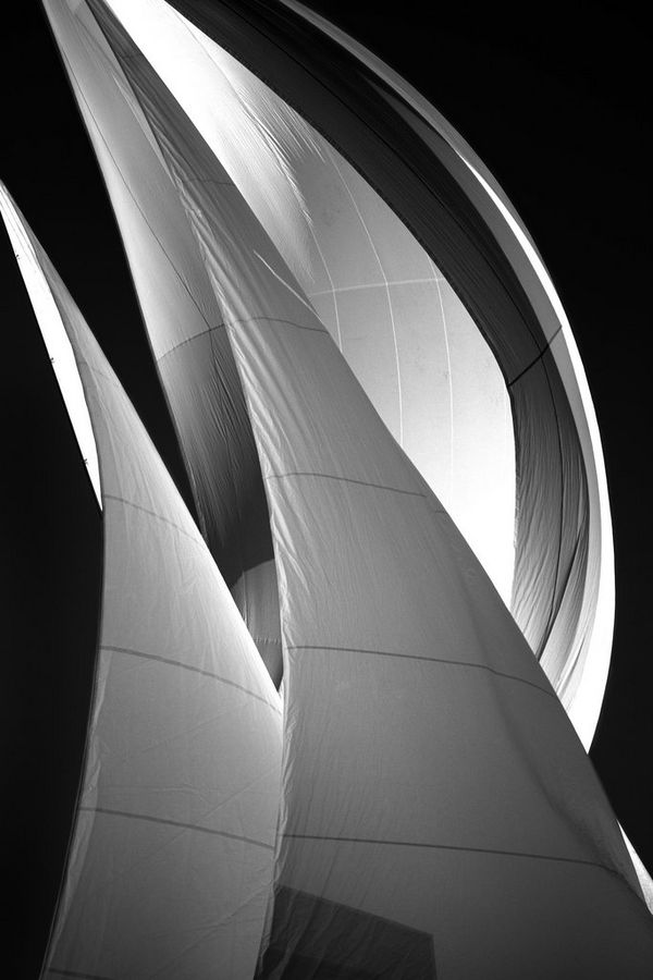 A black-and-white portrait-format photograph of a yacht's sails, taken by Carla Regler. 