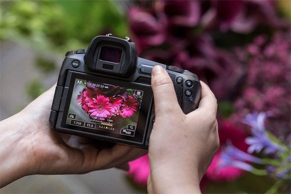 Photographer Guia Besana attaches a lens to the Canon EOS R.