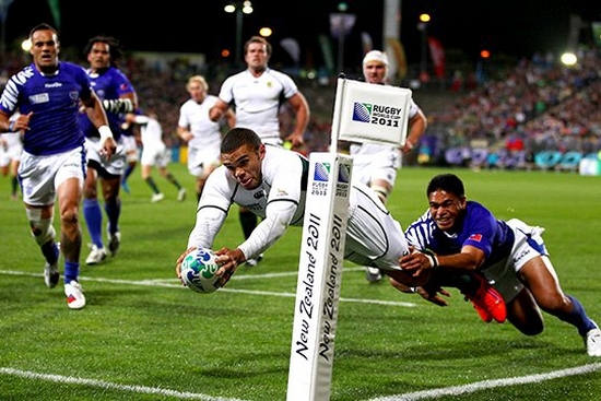 South Africa rugby player Bryan Habana dives to score a try, a Samoa rugby player grabbing his leg Photo by Hannah Peters.