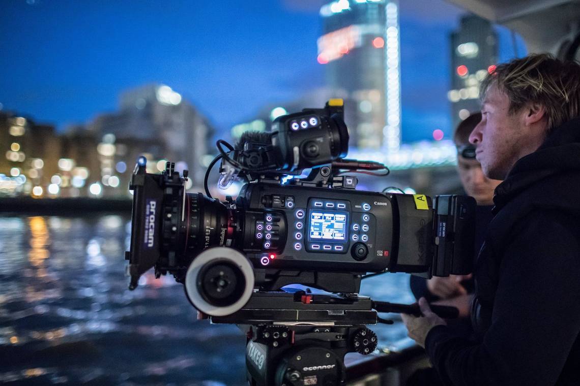 Cinematographer Steve Lawes and First AC Ben Margitich film a luxury river yacht at night on the Thames in central London with the Canon EOS C700.
