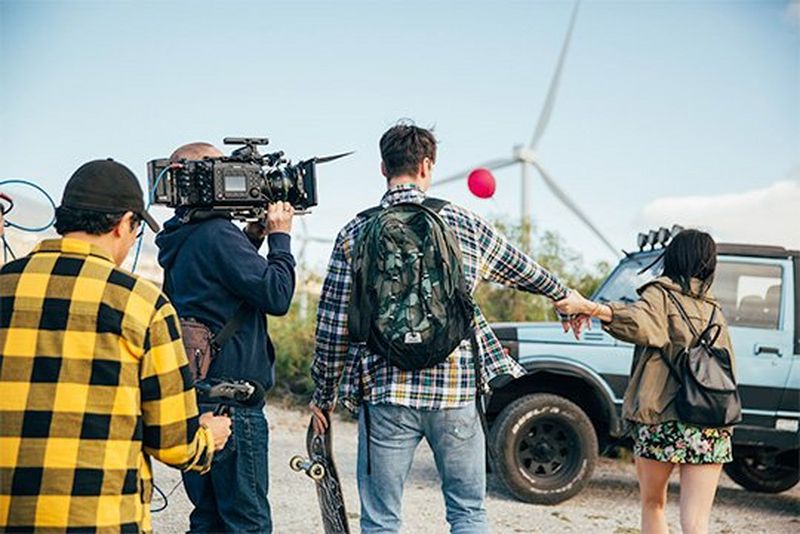 A cinematographer shoulders a Canon EOS C700 FF camera to shoot a short film featuring a young couple in the harsh sunlight of Tenerife.