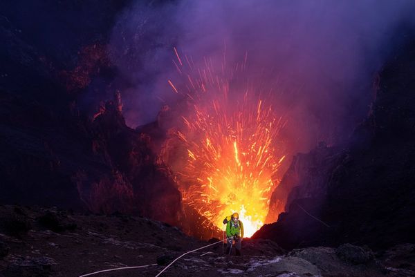A geologist abseiling into an active volcano. 
