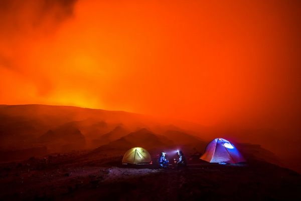 Three tents erected on the side of an active volcano. 