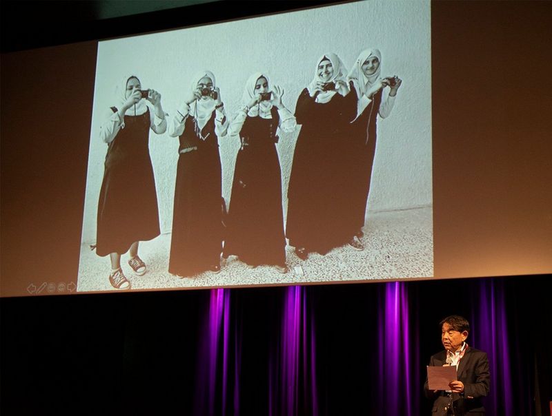 Yuichi Ishizuka, President and CEO of Canon Europe, Middle East and Africa, introduces the panel discussion about the project at the festival of photojournalism Visa pour l'Image 2019.