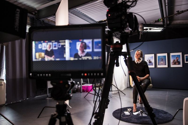 Freediver Helena Bourdillon sits on a stool in front of a video camera.
