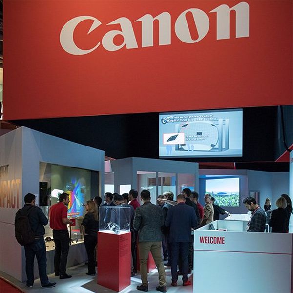 The Canon stand at the ISE trade show, full of visitors looking at imaging products.