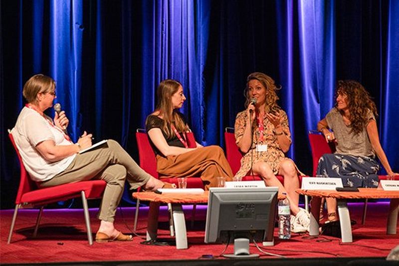 Hilary Roberts, Laura Morton and Catalina Martin-Chico look on as Ilvy Njiokiktjien speaks.