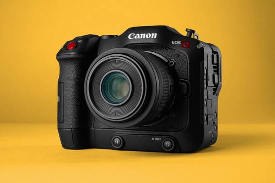 A Canon EOS C70 cinema camera, against a yellow background.