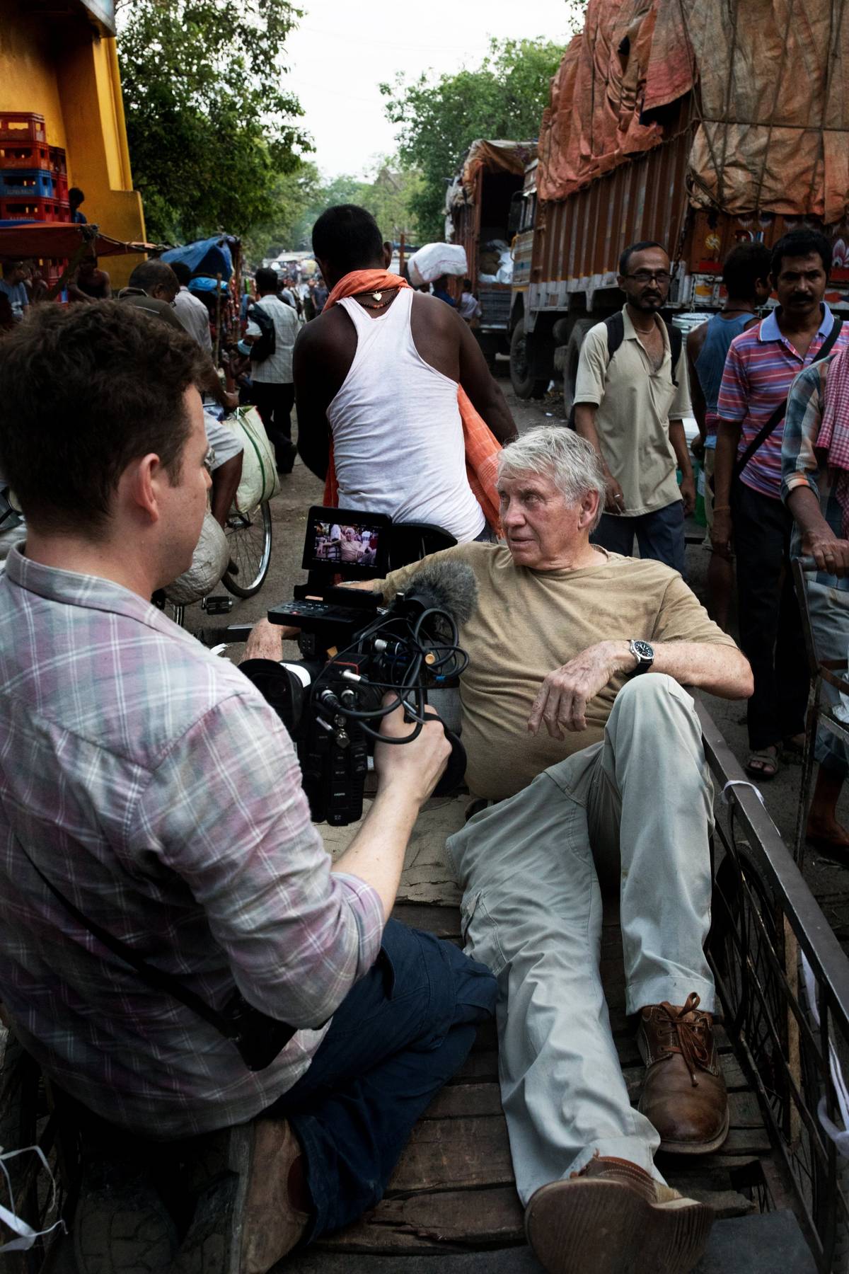 Cinematographer Chris Clarke films Sir Don McCullin through the streets of Kolkata. © Lance Miller