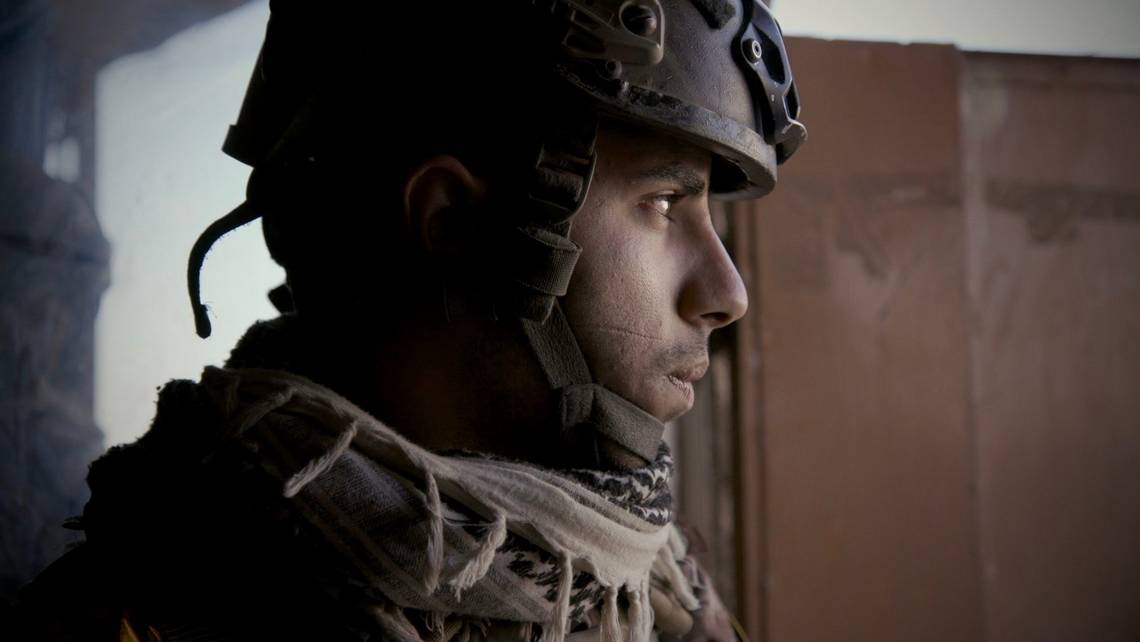 A side-on portrait of an Iraqi Special Operations Forces soldier wearing a helmet. Captured with a Canon EOS C300 Mark II in Mosul, 2016. ? Olivier Sarbil