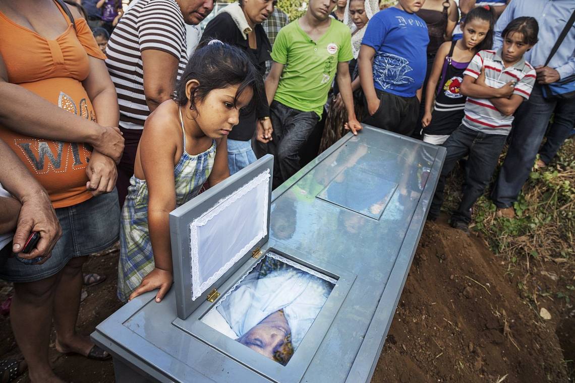 Family and friends gather at the graveside around the coffin of a former sugarcane worker in Chichigalpa, Nicaragua.