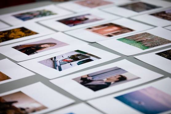 A selection of student portfolio images laid out on a table.