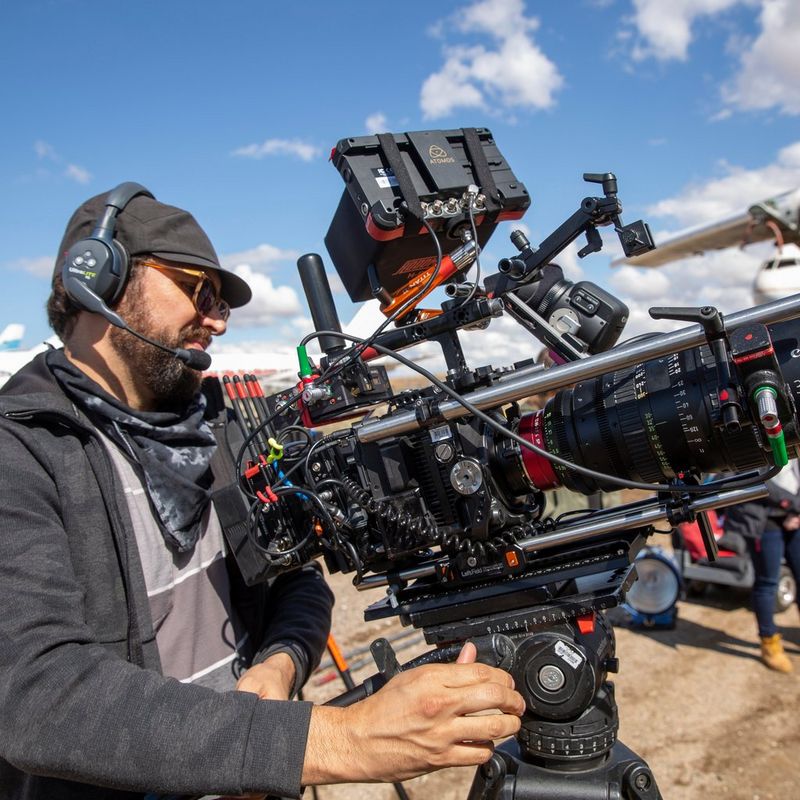 A camera operator using the Canon EOS C300 Mark III on an airfield shoot.
