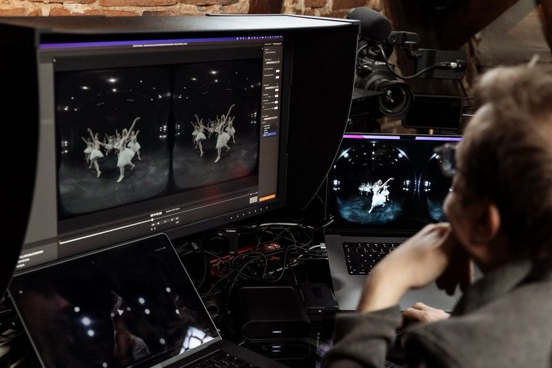 A man using Canon's EOS VR Utility software to process footage of ballet dancers captured by a Canon dual fisheye lens.