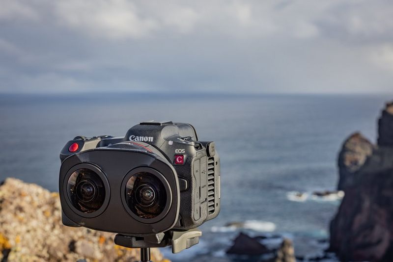 A Canon EOS R5 C hybrid camera, mounted on a tripod overlooking the sea, with a Canon RF 5.2mm F2.8L Dual Fisheye lens attached.