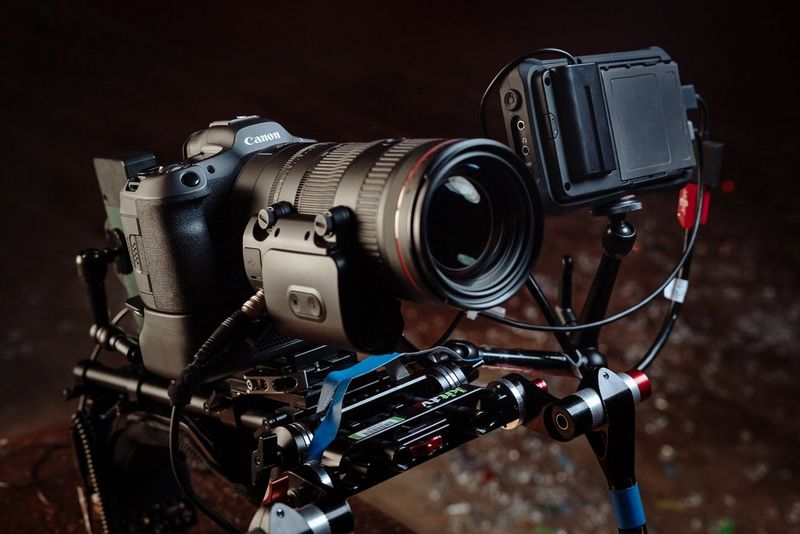 A Canon EOS R5 Mark II camera in a professional rig with external monitor and zoom lens with power zoom adapter.