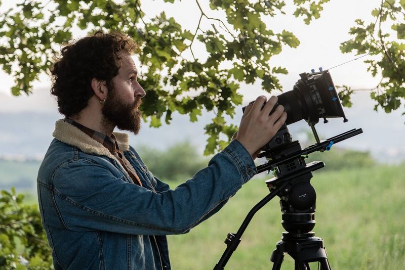 Cinematographer Ivan D'Antonio filming with the Canon EOS R5 with a filter on the lens.
