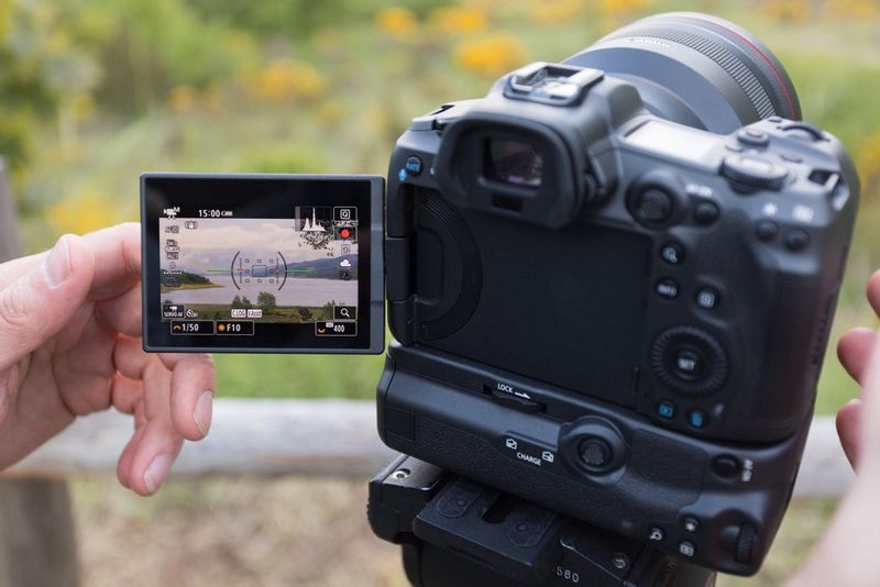 A Canon EOS R5 camera with its LCD screen flipped out.