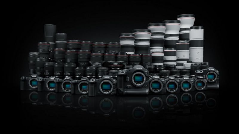 A row of Canon ֽ_격- System cameras lined up with an array of Canon lenses behind them, all set against a sleek black background.