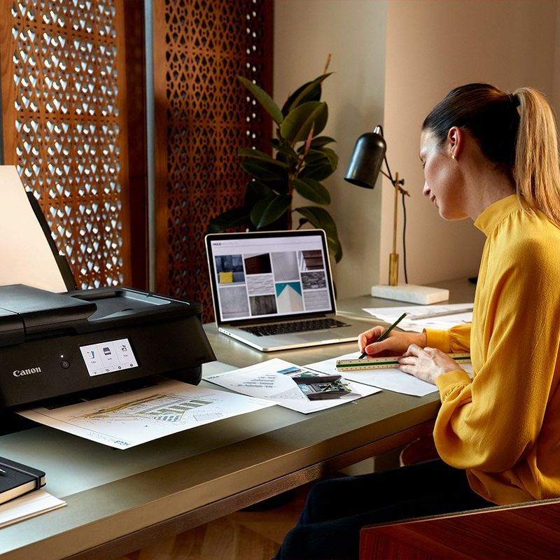 Female sketching technical drawings next to her Canon PIXMA TS9550