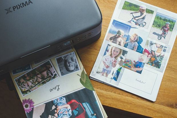 A Canon PIXMA TS5340 printer on a tabletop printing out photo collages.